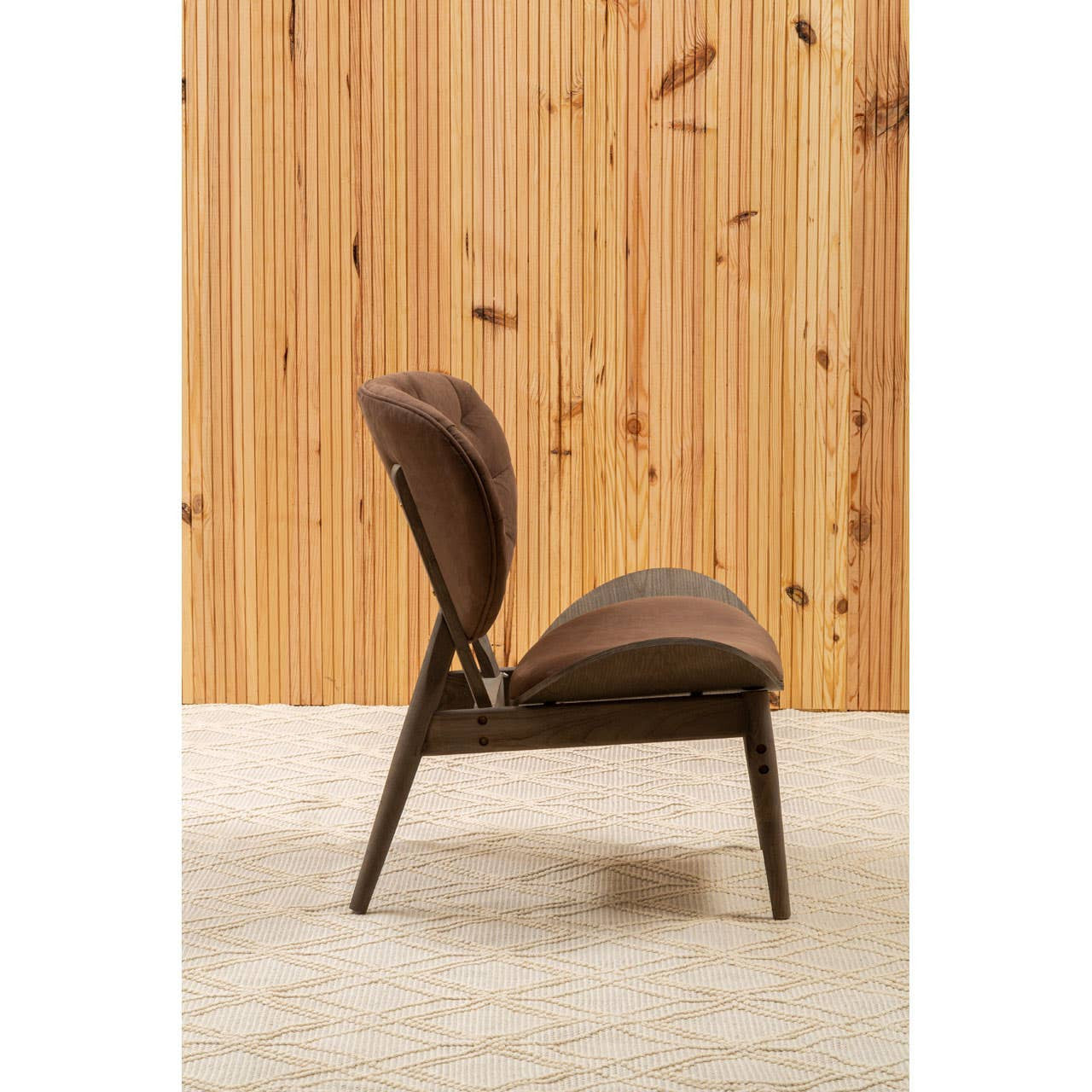 Brown velvet chair featuring a dark elm wood frame, showcasing a curved backrest and plush seating.