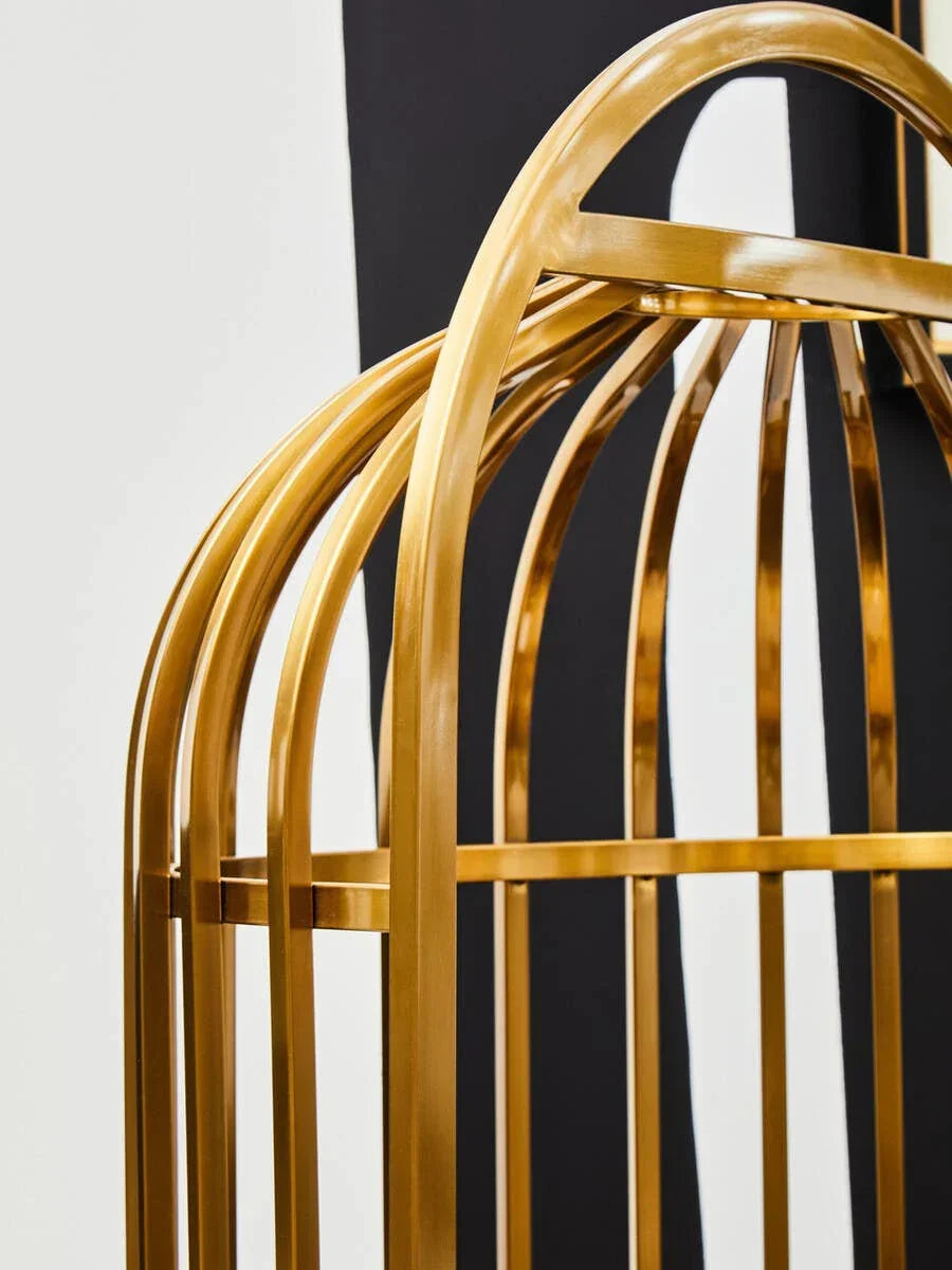 Gold metal frame of modern furniture with arched design against monochrome background