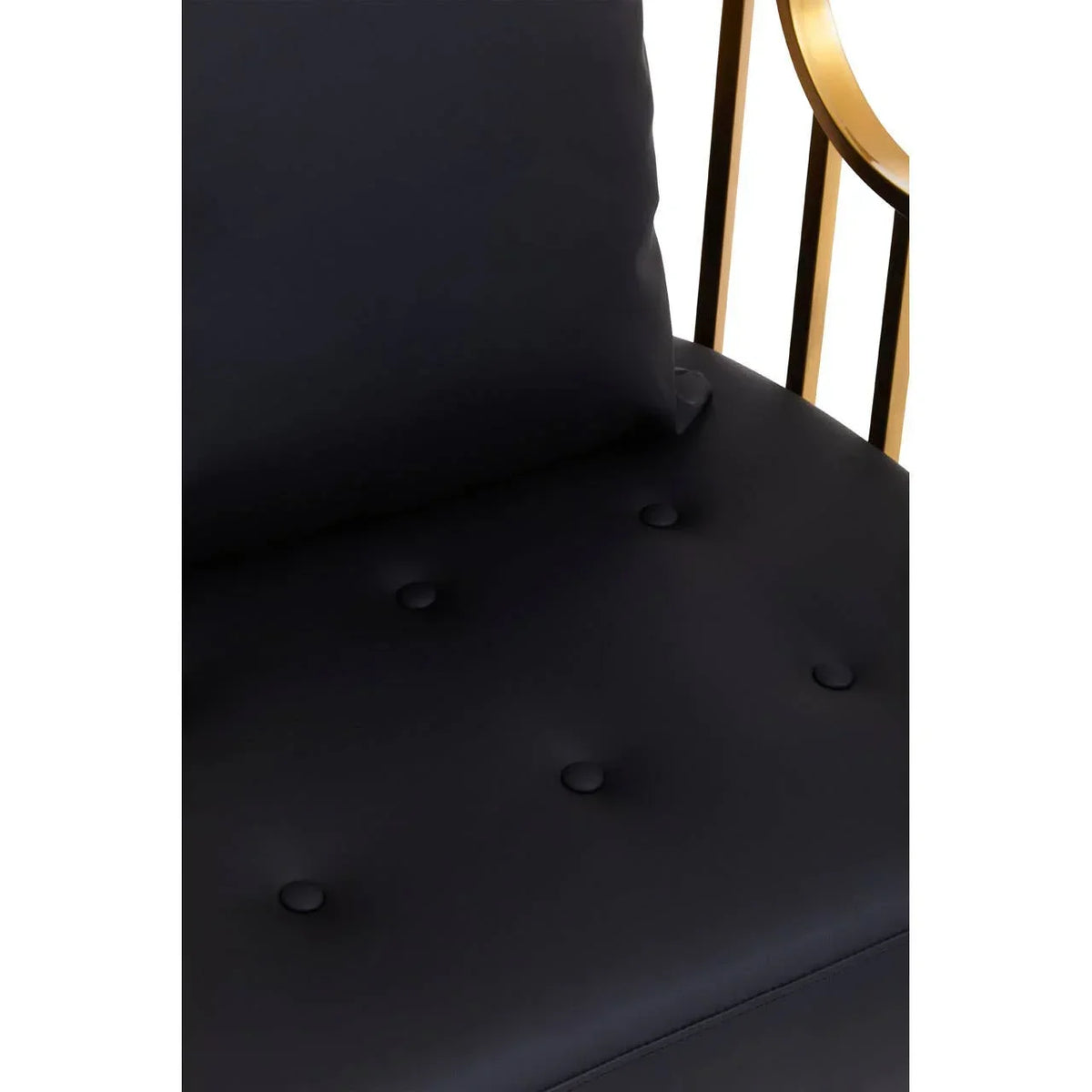 Black upholstered chair seat with button tufting and gold metal frame detail