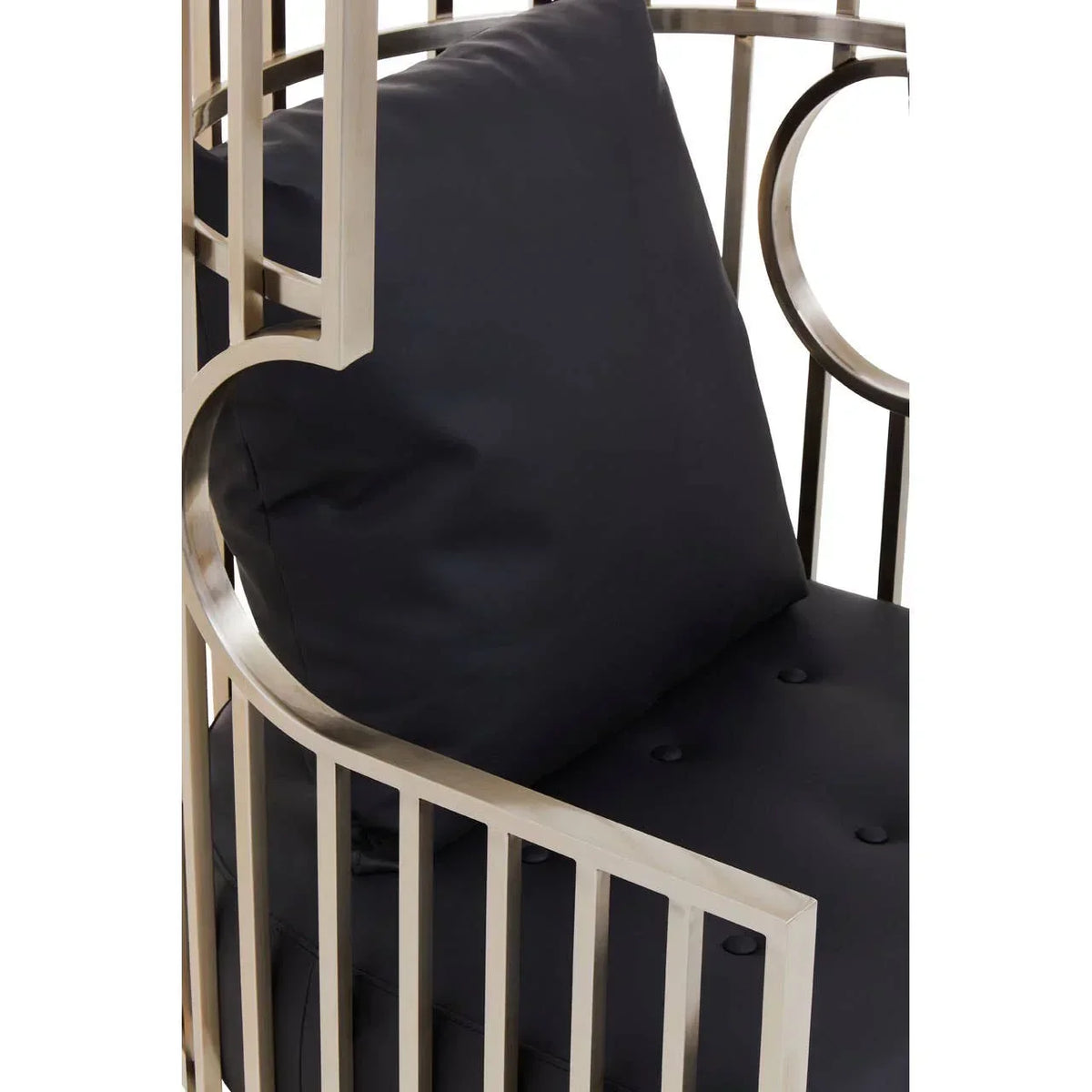 Close-up of metal armchair with black cushion and button-tufted seat