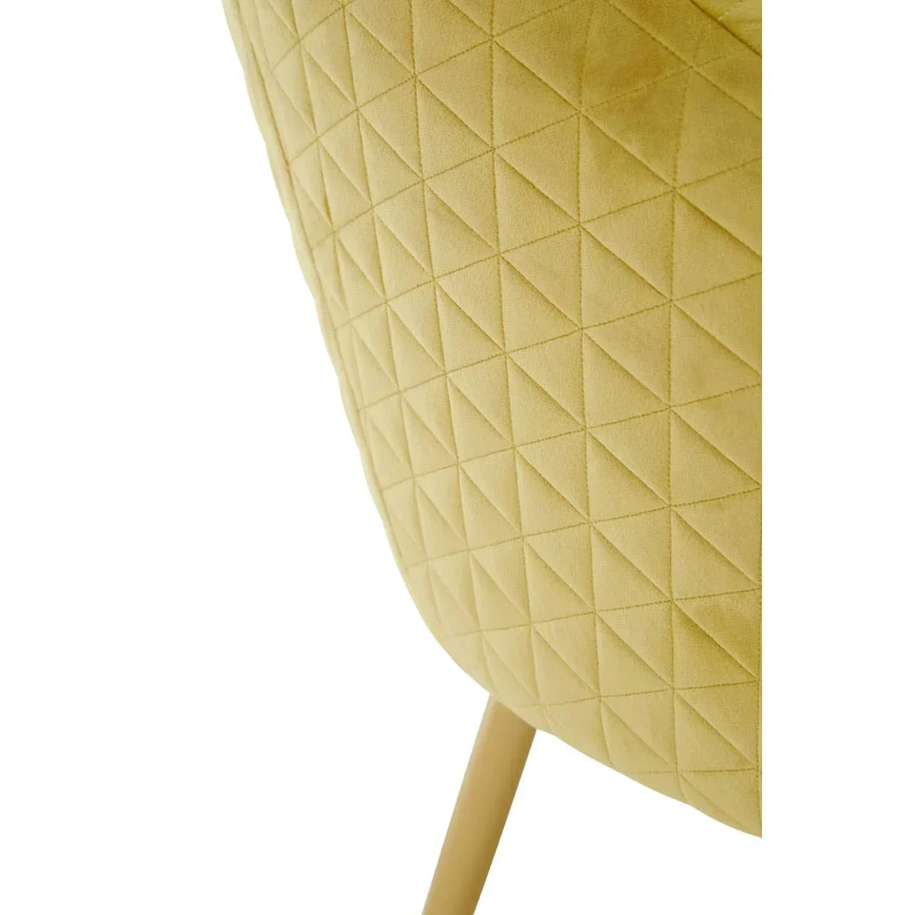 Closeup of yellow dining chair with quilted fabric and angled wood leg