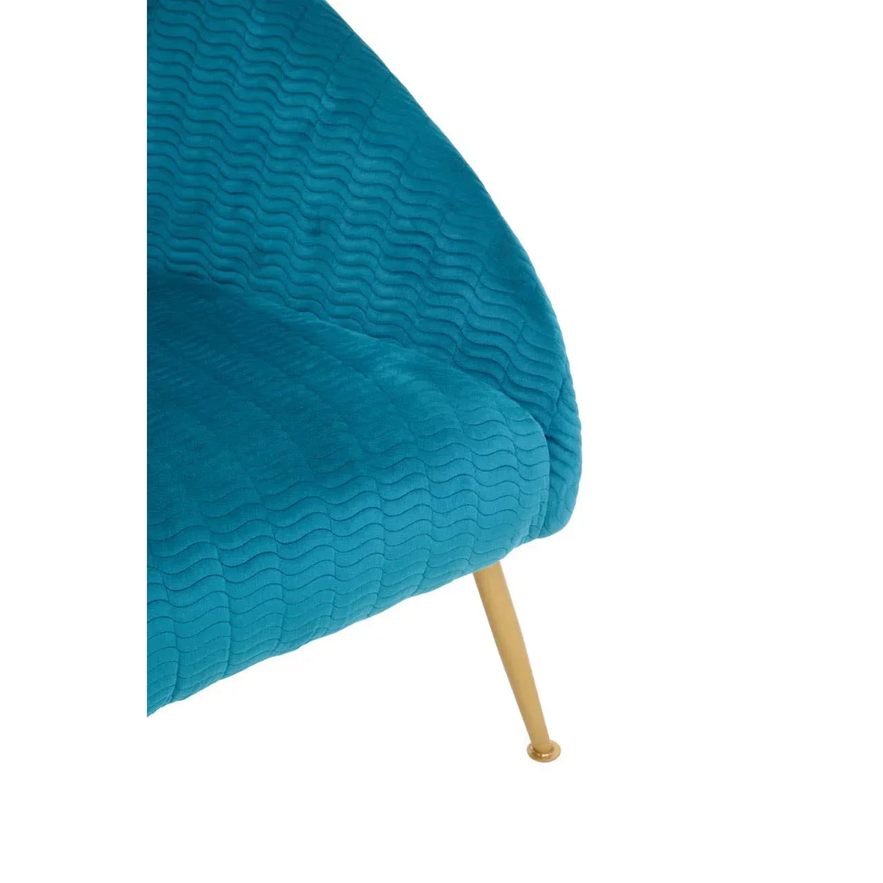 Blue velvet armchair with quilted pattern and gold metal leg, close-up view