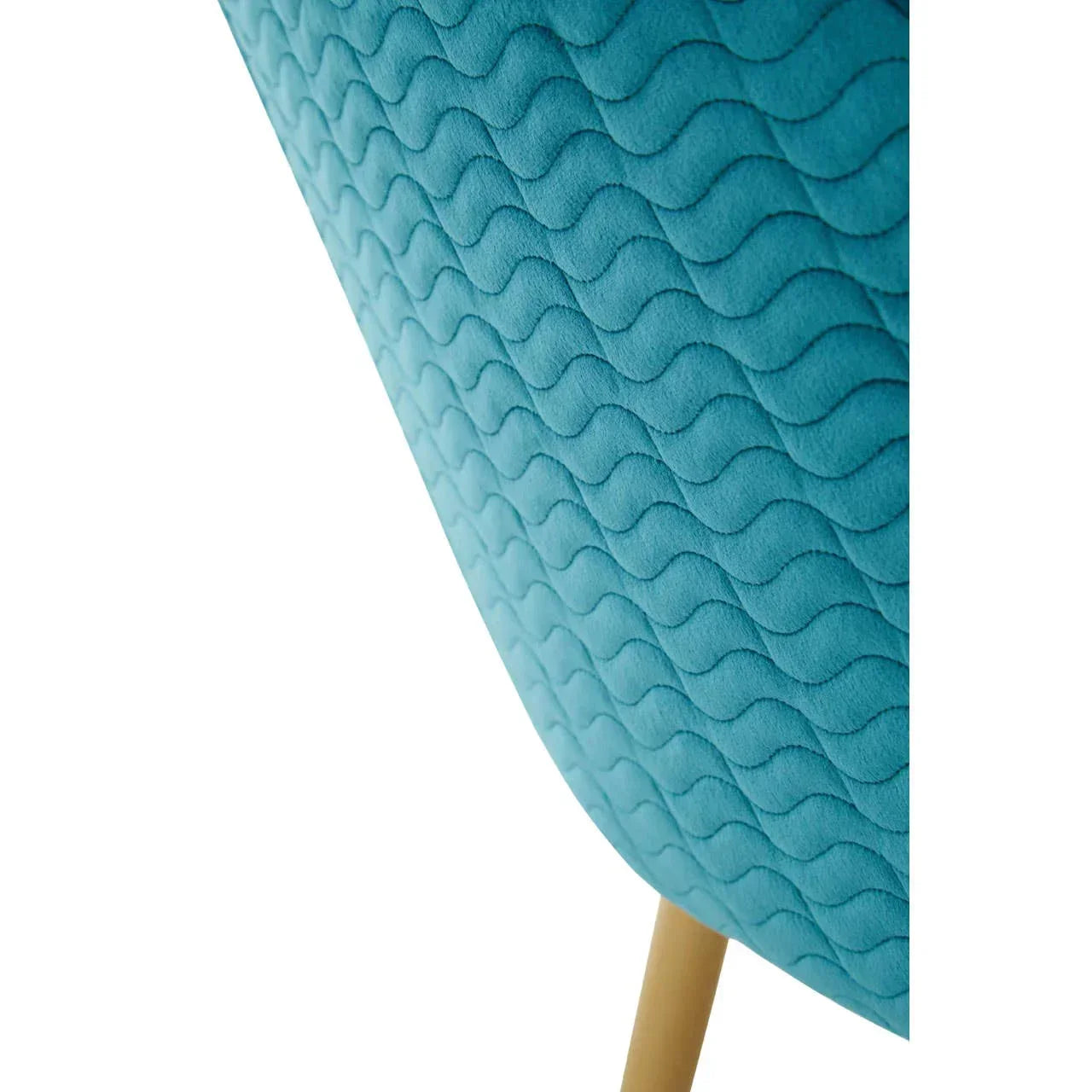 Closeup of blue fabric armchair with wavy quilted pattern and wooden leg