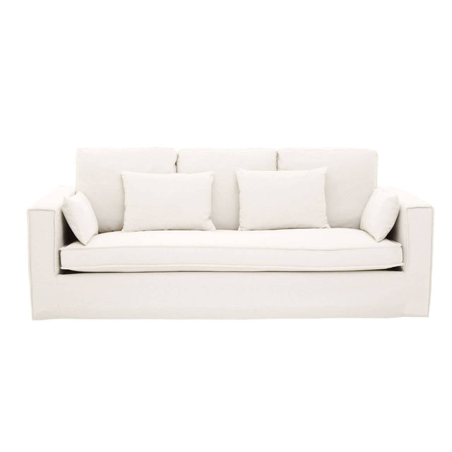 Cream-colored three-seat sofa featuring a modern design with plush cushions and three matching throw pillows. The sofa has a clean, minimalist silhouette and is upholstered in a soft fabric, making it suitable for various interior styles