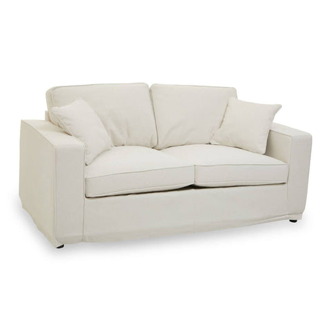 Cream fabric two-seat sofa with plush cushions and a modern design, featuring rounded arms and short, sleek legs. The sofa is styled for comfort and elegance, suitable for various interior decor