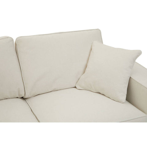 Cream fabric sofa with two seats, featuring soft cushions and a matching decorative pillow. The upholstery has a smooth texture, and the overall design is modern and minimalist