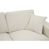 Cream fabric sofa with two seats, featuring soft cushions and a matching decorative pillow. The upholstery has a smooth texture, and the overall design is modern and minimalist