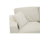 Cream fabric sofa with a rounded armrest and a plush back cushion, featuring a small decorative pillow on the seat. The fabric has a soft texture, and the overall design is modern and minimalist