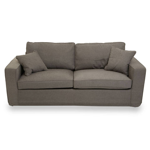 Three-seat sofa upholstered in grey fabric, featuring two large back cushions and two smaller accent pillows, with a modern, boxy design and sturdy armrests