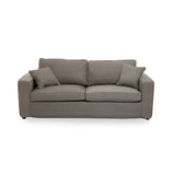 Three-seat sofa upholstered in soft grey fabric, featuring two plush back cushions and two smaller accent pillows. The sofa has a modern, minimalist design with clean lines and a sturdy base