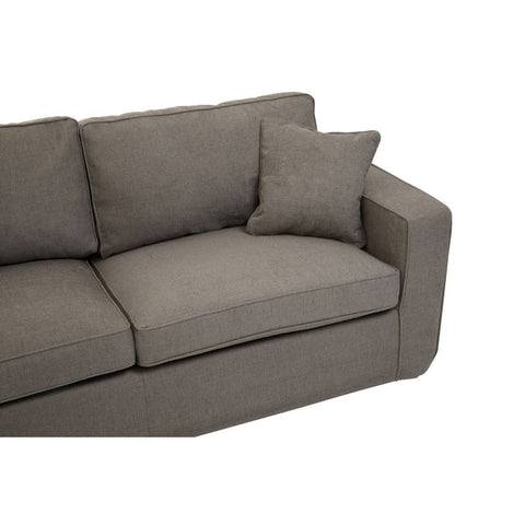 Three-seat sofa upholstered in soft grey fabric, featuring a modern design with clean lines. The sofa includes plush back cushions and a matching decorative pillow, providing comfort and style. The armrest is slightly rounded, enhancing the contemporary look
