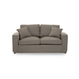Two-seat sofa in a soft grey fabric, featuring a simple, modern design with rounded arms and two plush back cushions. The sofa is set against a plain white background, highlighting its neutral color and contemporary style