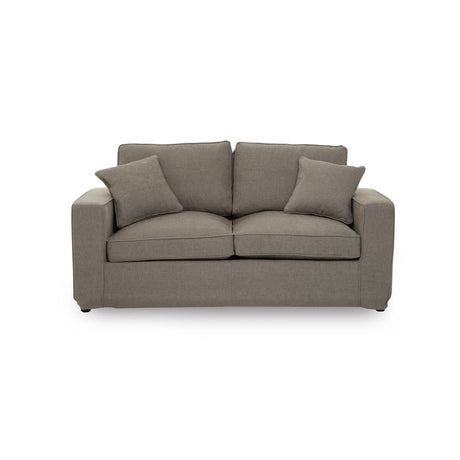 Two-seat sofa in a soft grey fabric, featuring a simple, modern design with rounded arms and two plush back cushions. The sofa is set against a plain white background, highlighting its neutral color and contemporary style