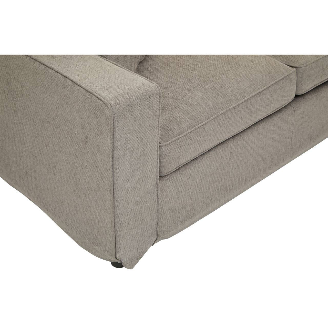 A close-up view of the corner of a grey sofa featuring a clean, modern design with straight lines and a soft fabric texture. The sofa has a low profile and is supported by small, discreet legs. The cushion appears plush and comfortable, enhancing the overall inviting look of the furniture piece