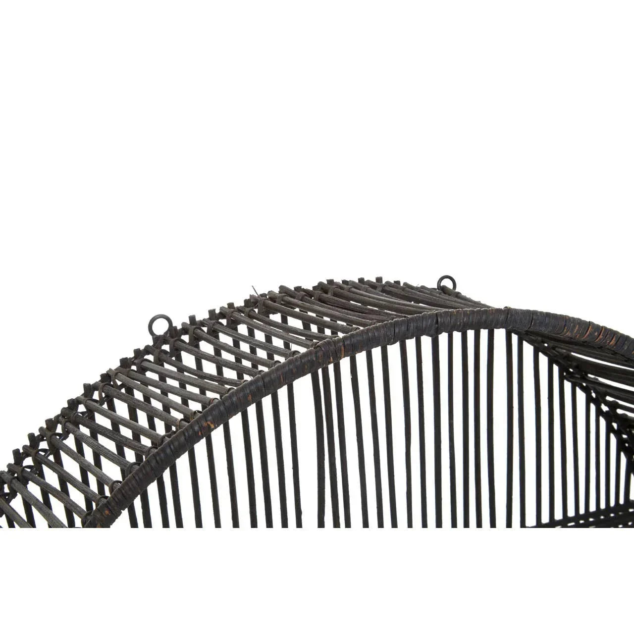 Closeup of dark rattan furniture frame showing woven texture and curved detailing