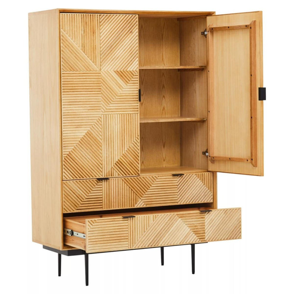 Natural finish cabinet featuring a geometric design on the front, with two open shelves and two drawers at the bottom. The cabinet has a single door that is slightly ajar, revealing the interior shelves. It stands on slender black legs, adding a modern touch to the overall design