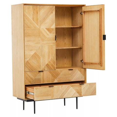 Natural finish cabinet featuring a geometric design on the front, with two open shelves and two drawers at the bottom. The cabinet has a single door that is slightly ajar, revealing the interior shelves. It stands on slender black legs, adding a modern touch to the overall design