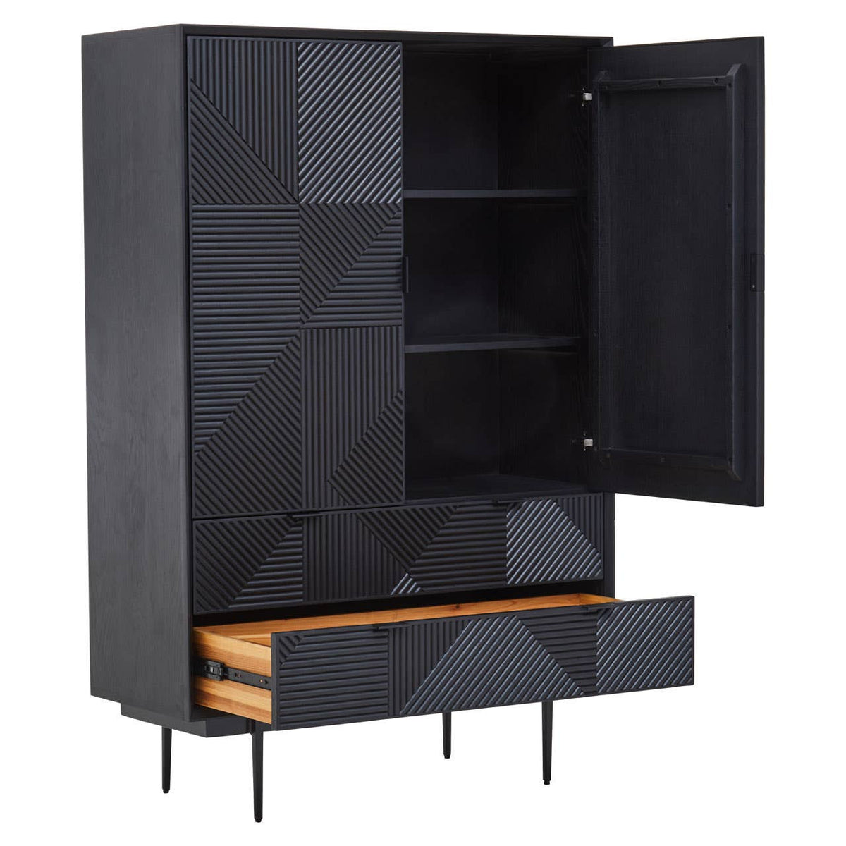 A tall cabinet with a black finish featuring carved geometric patterns on the front. The cabinet has two shelves visible inside, with one door open to reveal the interior. Below, there is a wooden drawer with a natural finish, positioned on slender black legs