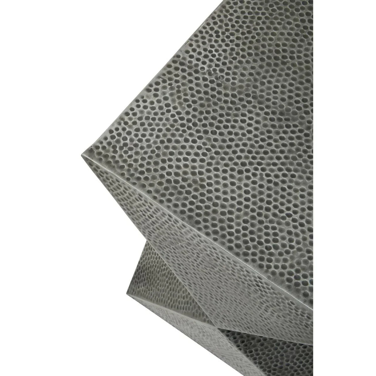 Close-up of textured metallic side table with geometric design