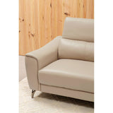 Stone leather sofa with a sleek design, featuring a comfortable armrest and an adjustable headrest. The sofa is positioned against a wooden wall, showcasing a modern aesthetic. The legs of the sofa are metallic, adding a contemporary touch. A soft rug is visible beneath the sofa, enhancing the cozy atmosphere