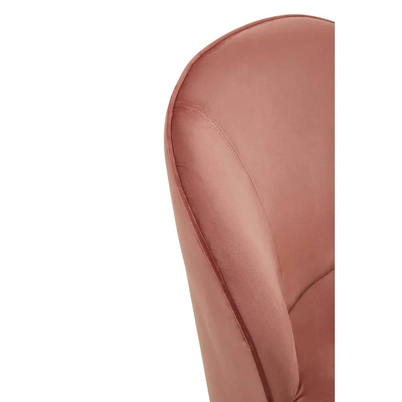 Close-up of blush pink velvet armchair backrest with curved seam detail