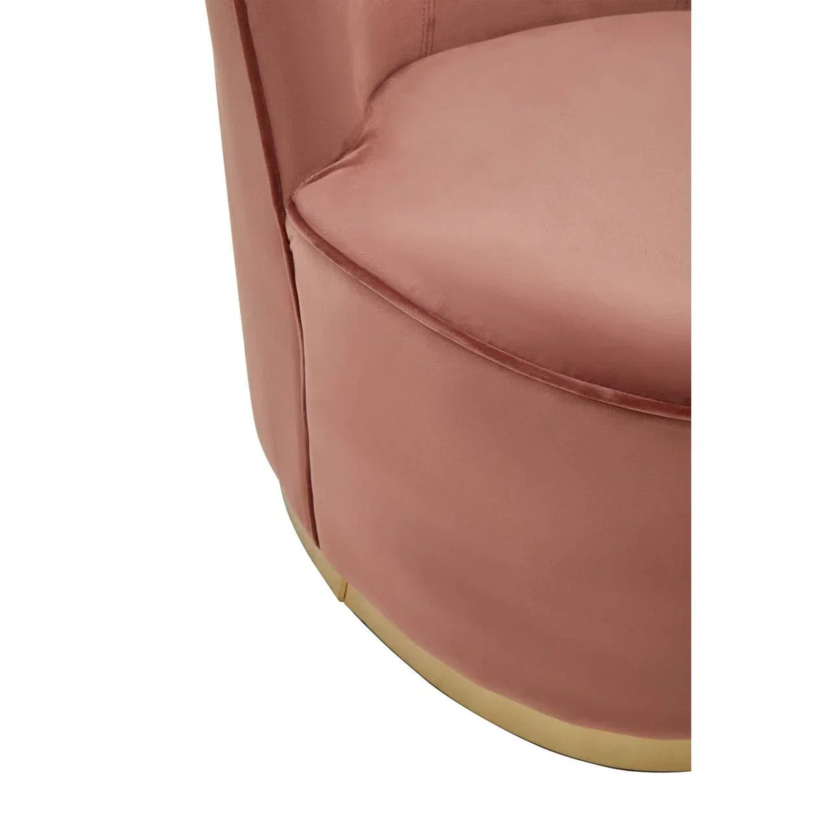 Close-up of pink velvet armchair with gold base and rounded seat cushion