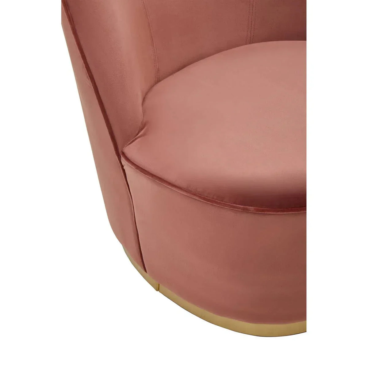 Closeup of pink velvet armchair seat with gold base trim