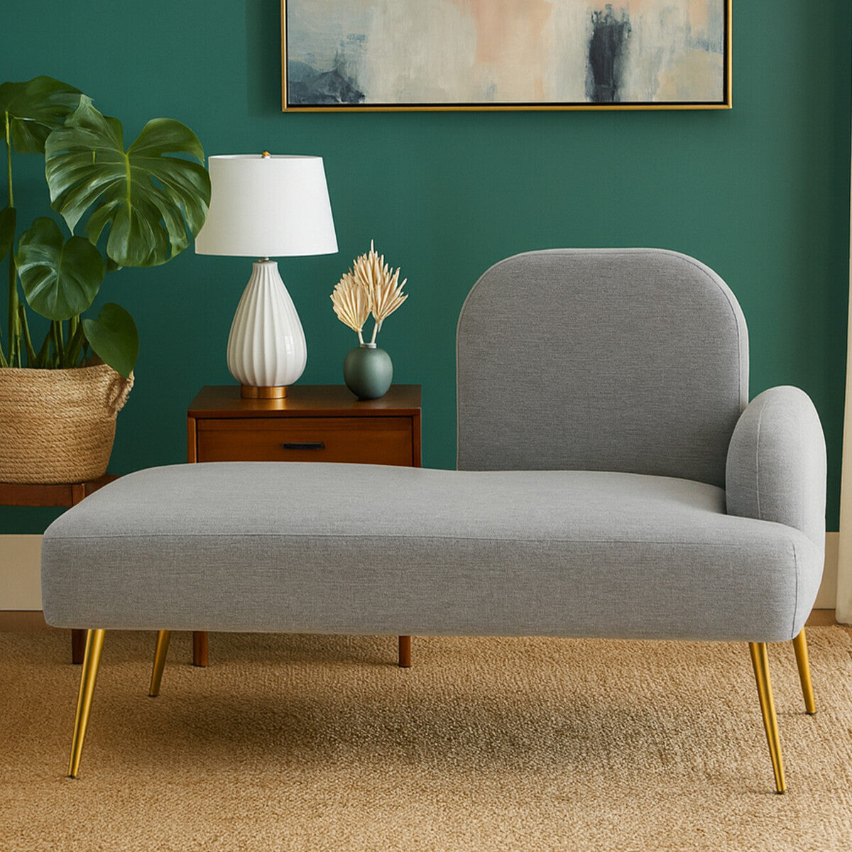 Heather grey right hand chaise longue with a curved backrest and a single armrest, set against a green wall. A white lamp and a decorative item are on a wooden side table beside the chaise, with a potted plant in the background and a light-colored rug underneath