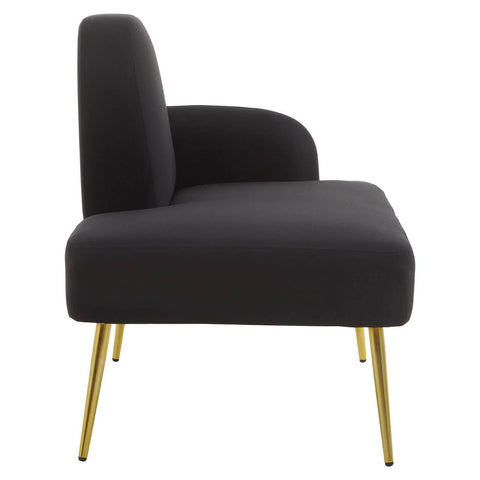 A sleek black chaise longue with a high back and curved armrest, supported by slender gold legs, showcasing a modern and minimalist design