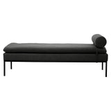 Dark grey upholstered daybed with cylindrical bolster and slim metal legs, side view