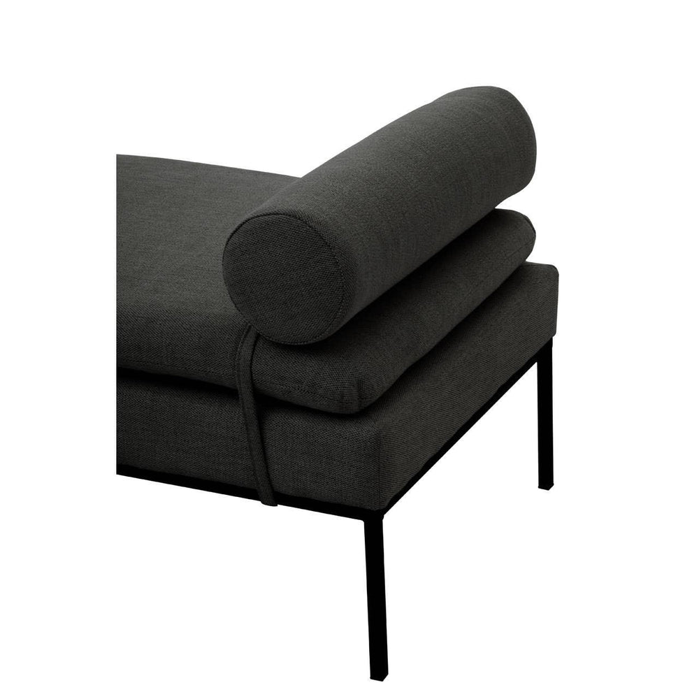 Dark fabric chaise lounge with bolster cushion and slim black metal legs, side angle view