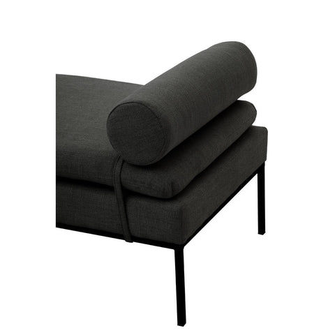 Dark fabric chaise lounge with bolster cushion and slim black metal legs, side angle view