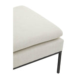 Close-up of cream fabric sofa corner with metal leg and cushioned seat