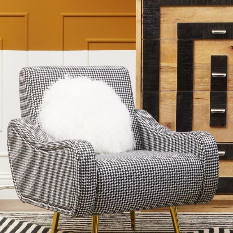 Houndstooth accent chair with gold legs and white cushion in modern living room