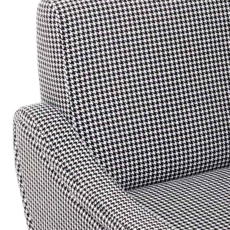 Houndstooth fabric armchair closeup showing curved armrest and backrest detail