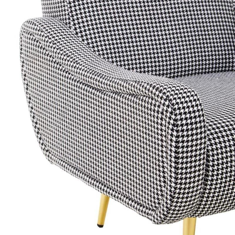 Houndstooth armchair with curved armrest and gold metal legs, close side view