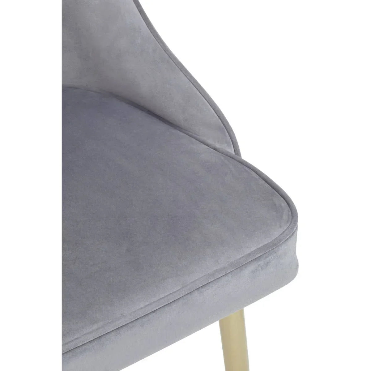 Closeup of grey velvet dining chair seat with light wood leg