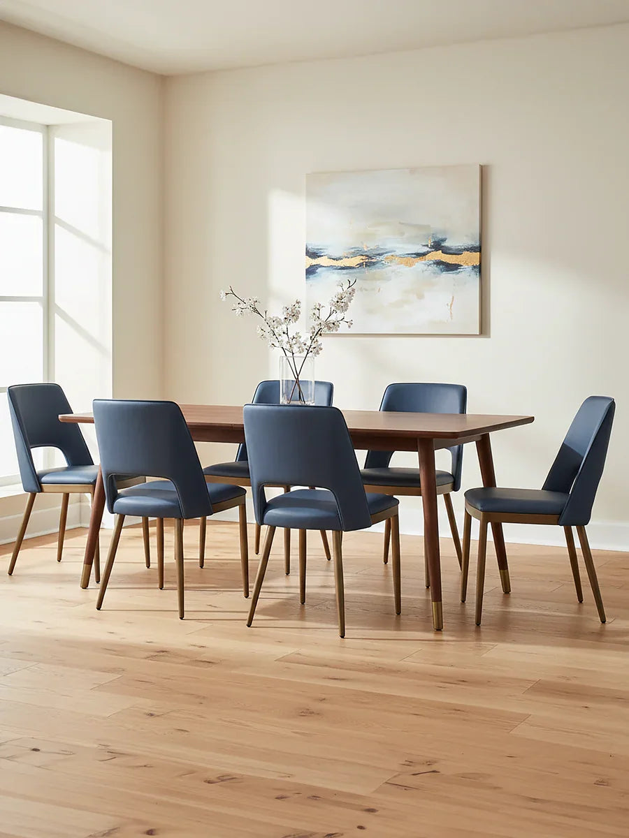 Walnut dining table with six blue upholstered chairs in a modern dining room