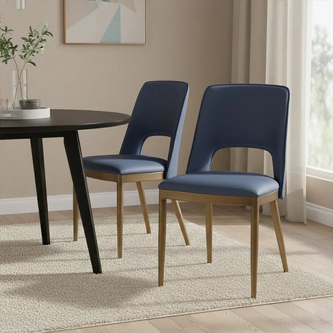Pair of blue dining chairs with wooden legs beside black round table in modern dining room