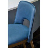 Blue faux leather dining chair with cut-out backrest and wooden legs beside counter