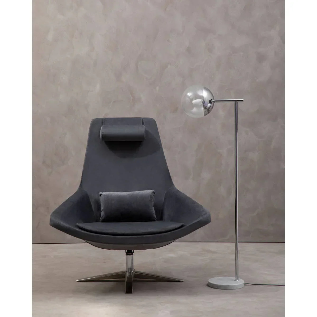 Grey swivel accent chair with cushion next to modern floor lamp in minimalist room