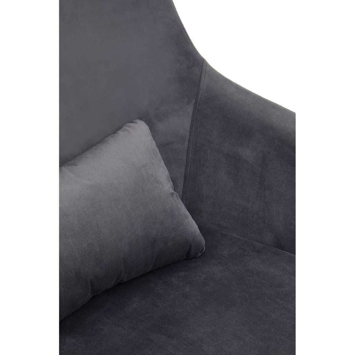 Close view of dark grey velvet sofa with matching cushion and high backrest
