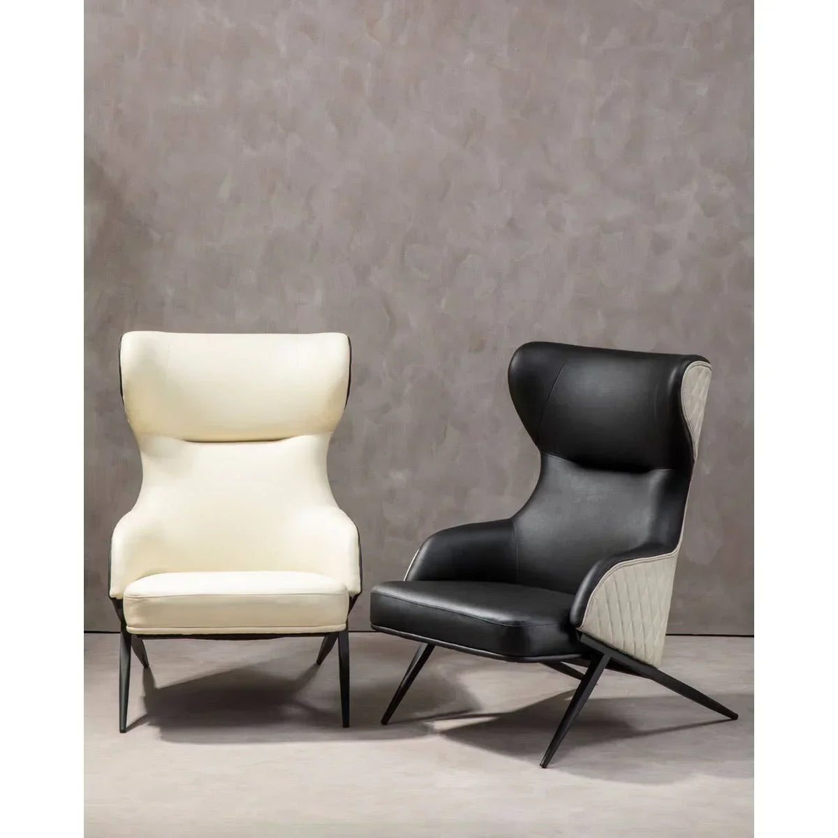 Modern high back accent chairs in cream and black leather with angled metal legs