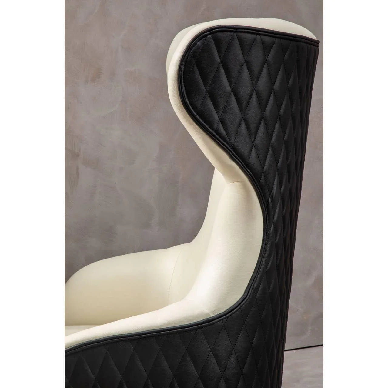 Diamond-stitched black and cream accent chair with high backrest, side profile view