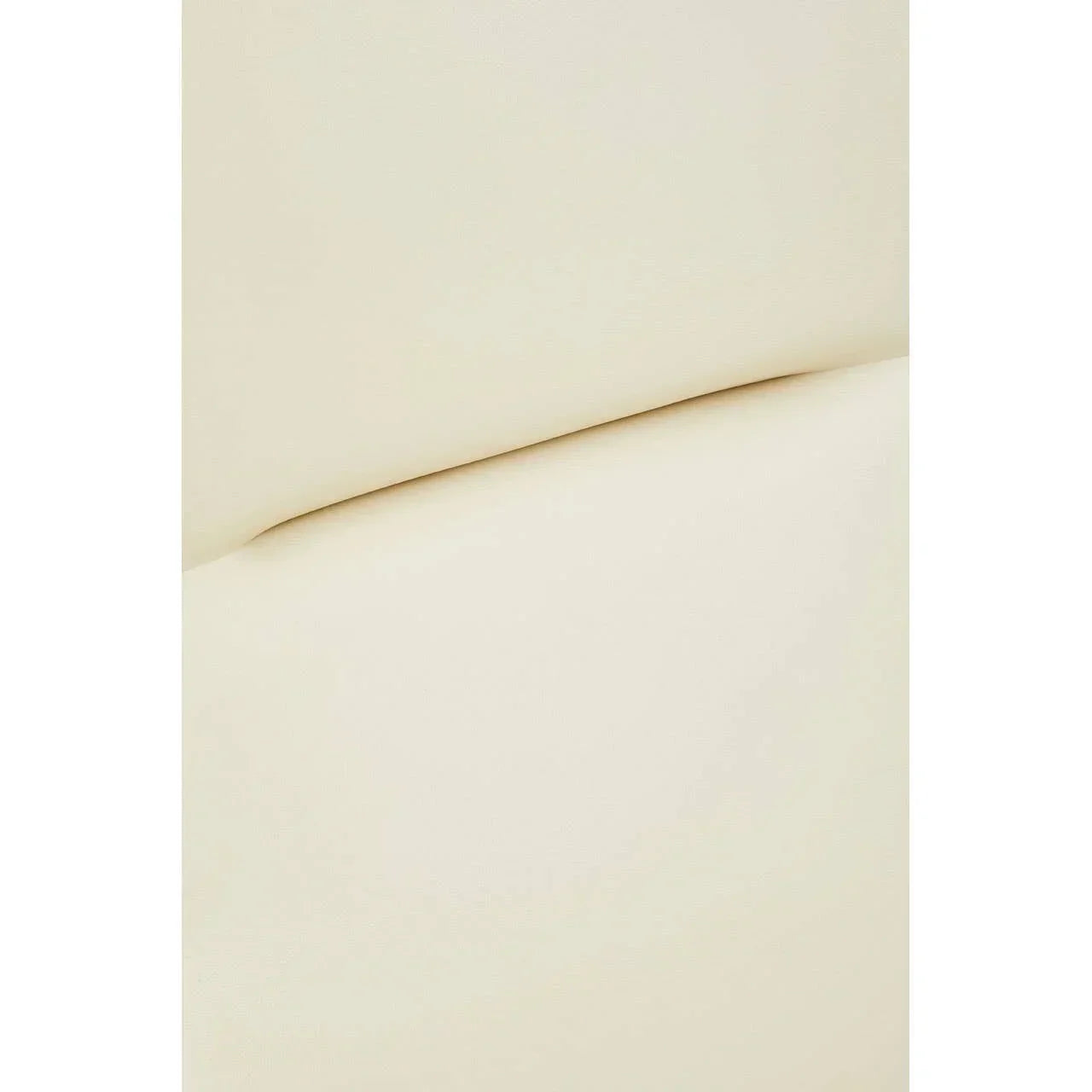 Closeup of cream leather sofa cushion with smooth upholstery detail