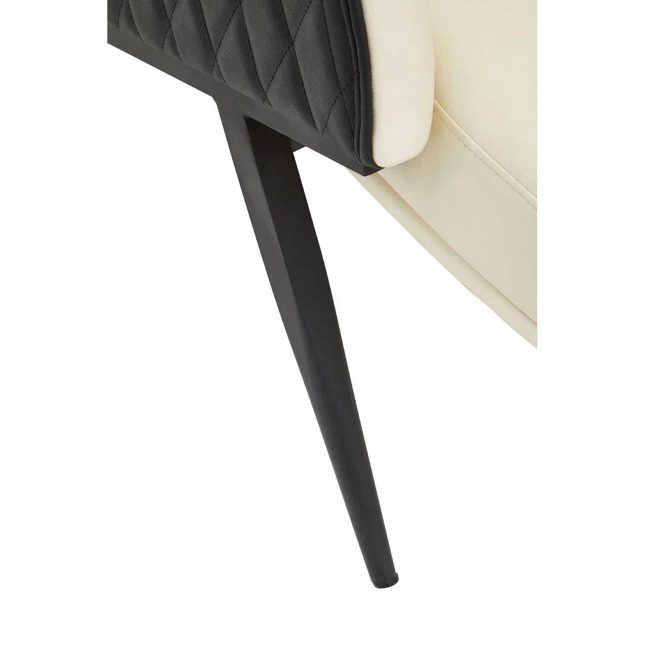 Black metal chair leg with quilted fabric detail and cream upholstery close-up