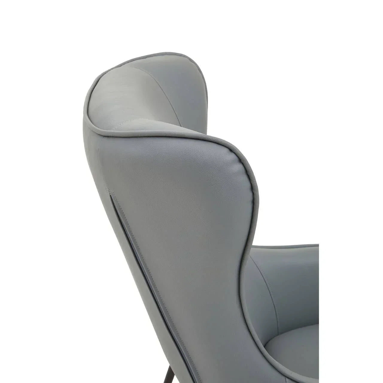 Close-up of grey leather armchair with curved high backrest