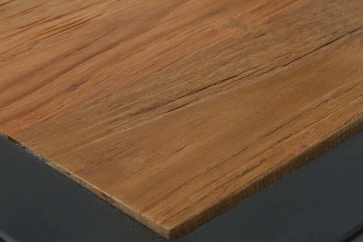 Close-up of wooden dining table top with natural grain and black metal edge