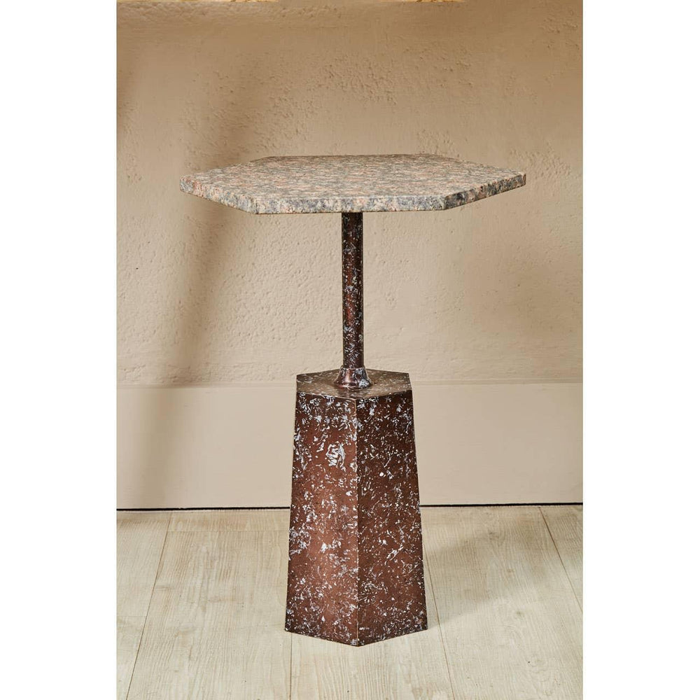Hexagonal marble top side table with brown textured base on wooden floor