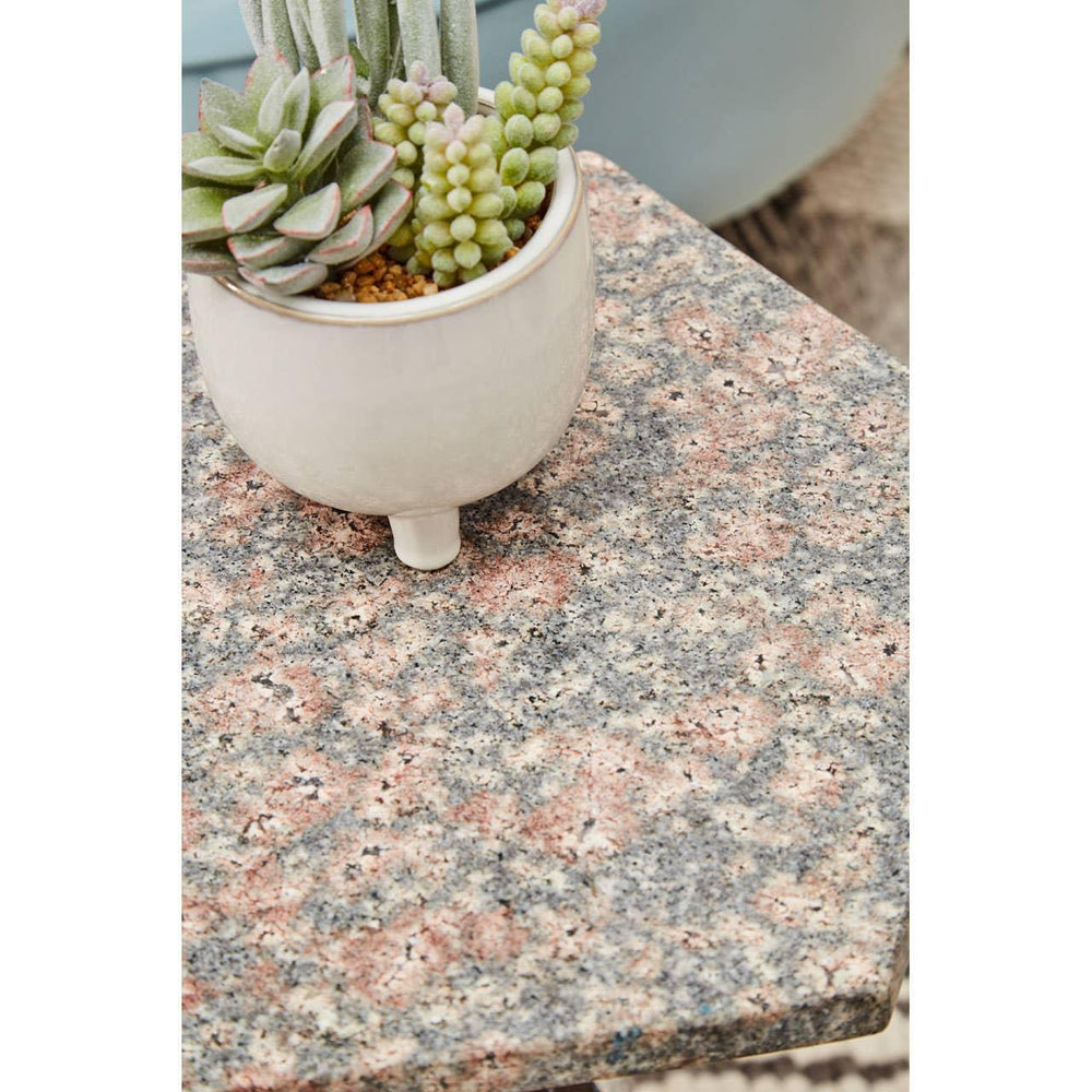 Granite side table with potted succulent plant, close-up of textured stone surface